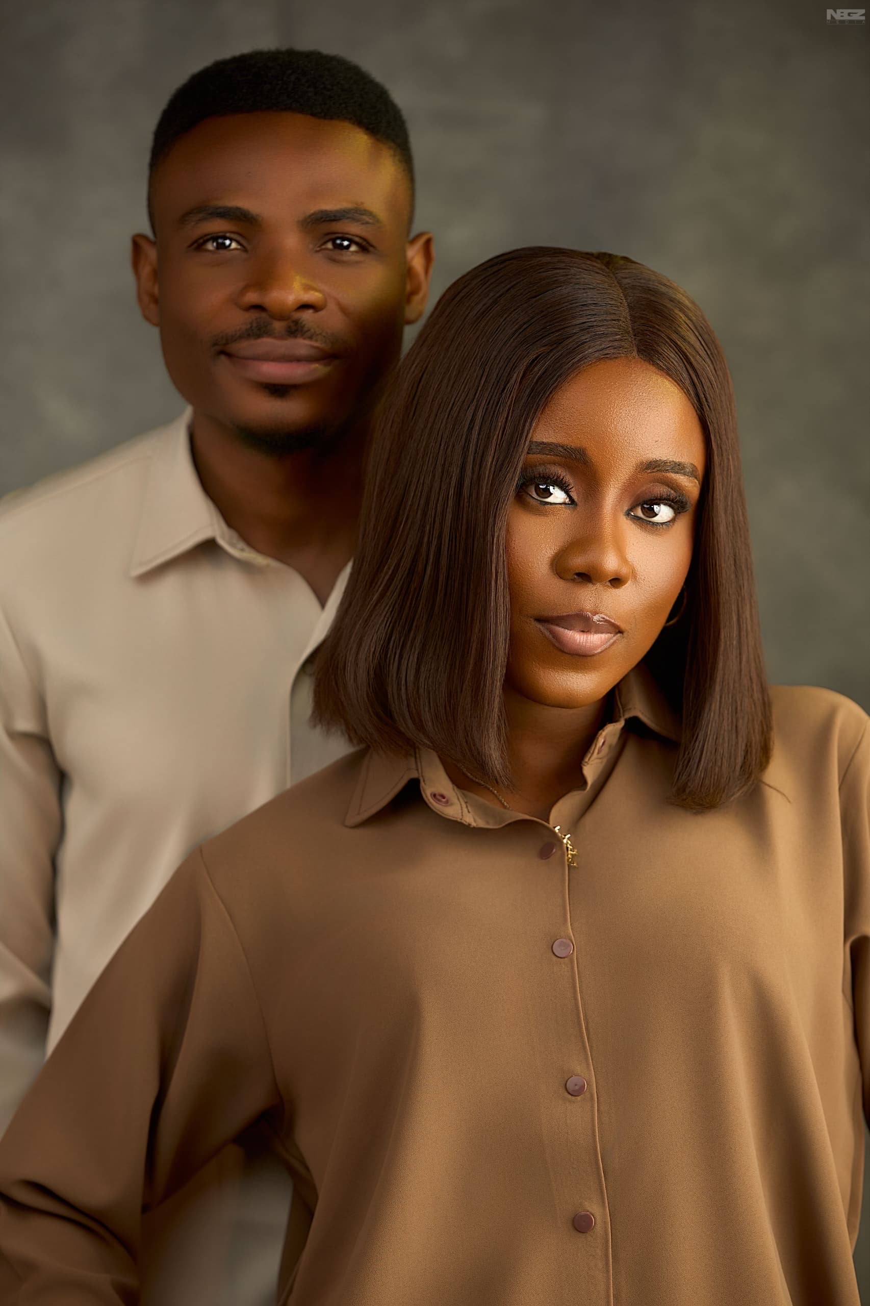 James standing quietly behind Edi, who looks softly off-camera